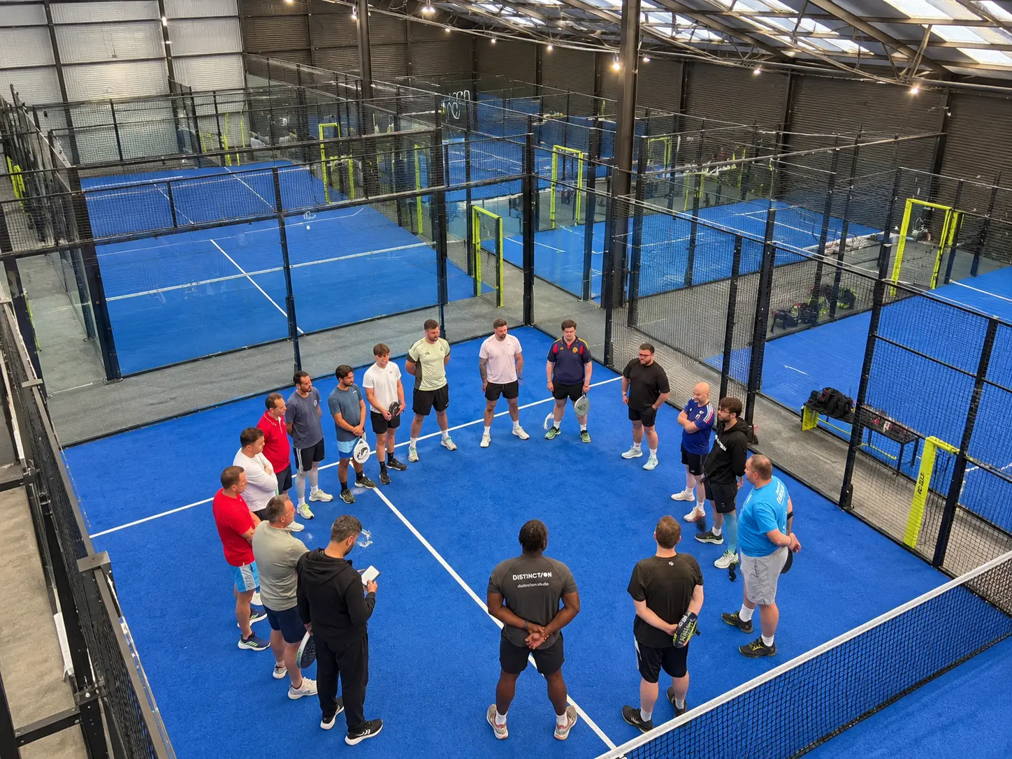 Business professionals networking after a padel session in Nottingham